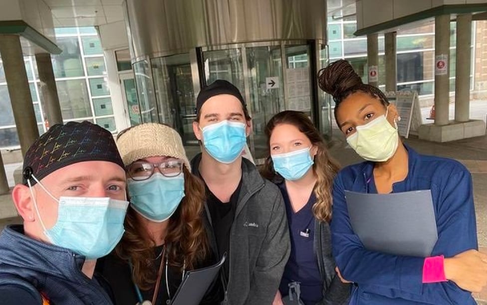 A group of travel nurse professionals with masks on.